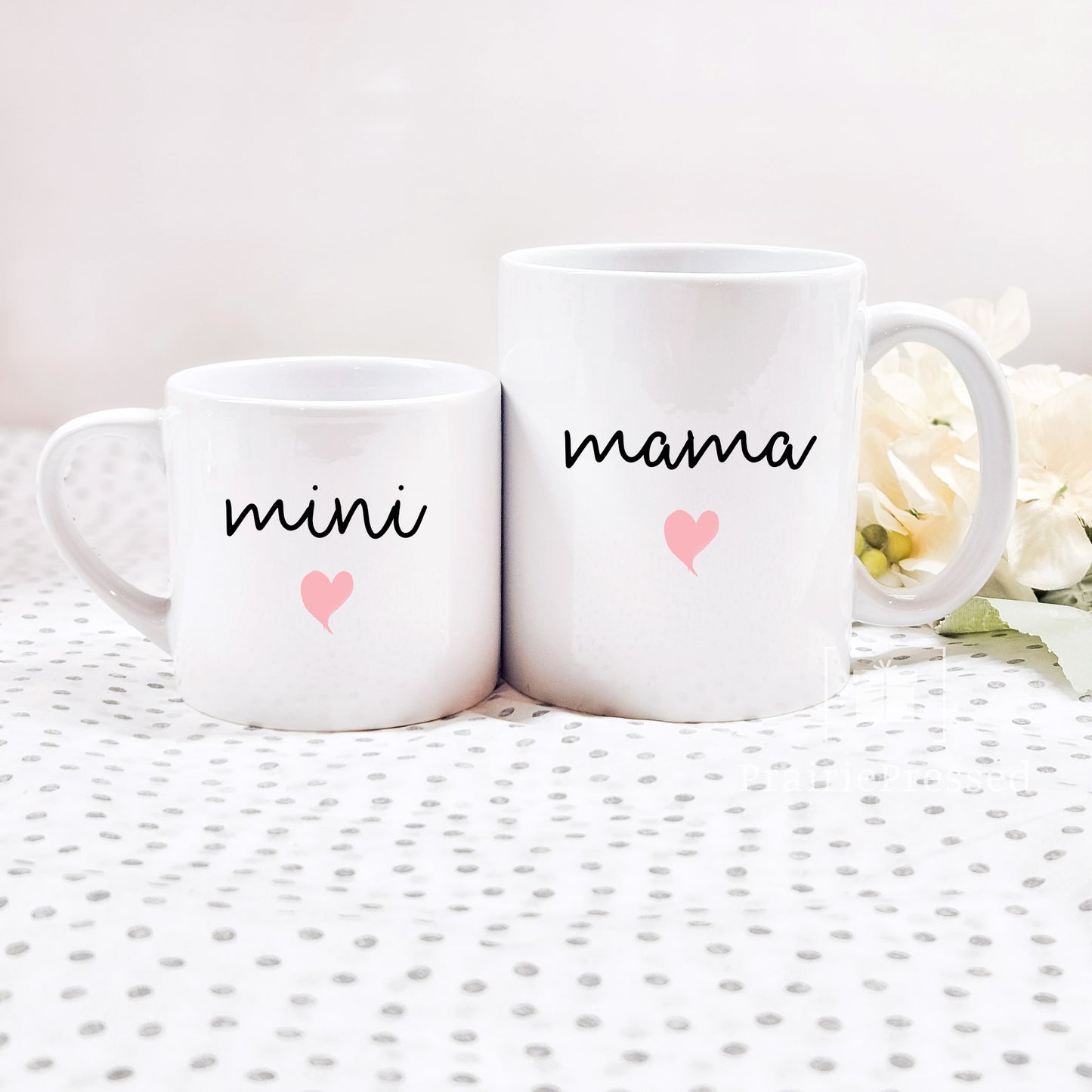 Adorable Mama Mini Ceramic Mother's Day Mug set with cute font and pink heart on each. Mug set includes one child size 5oz white mug and one 11oz white standard coffee mug