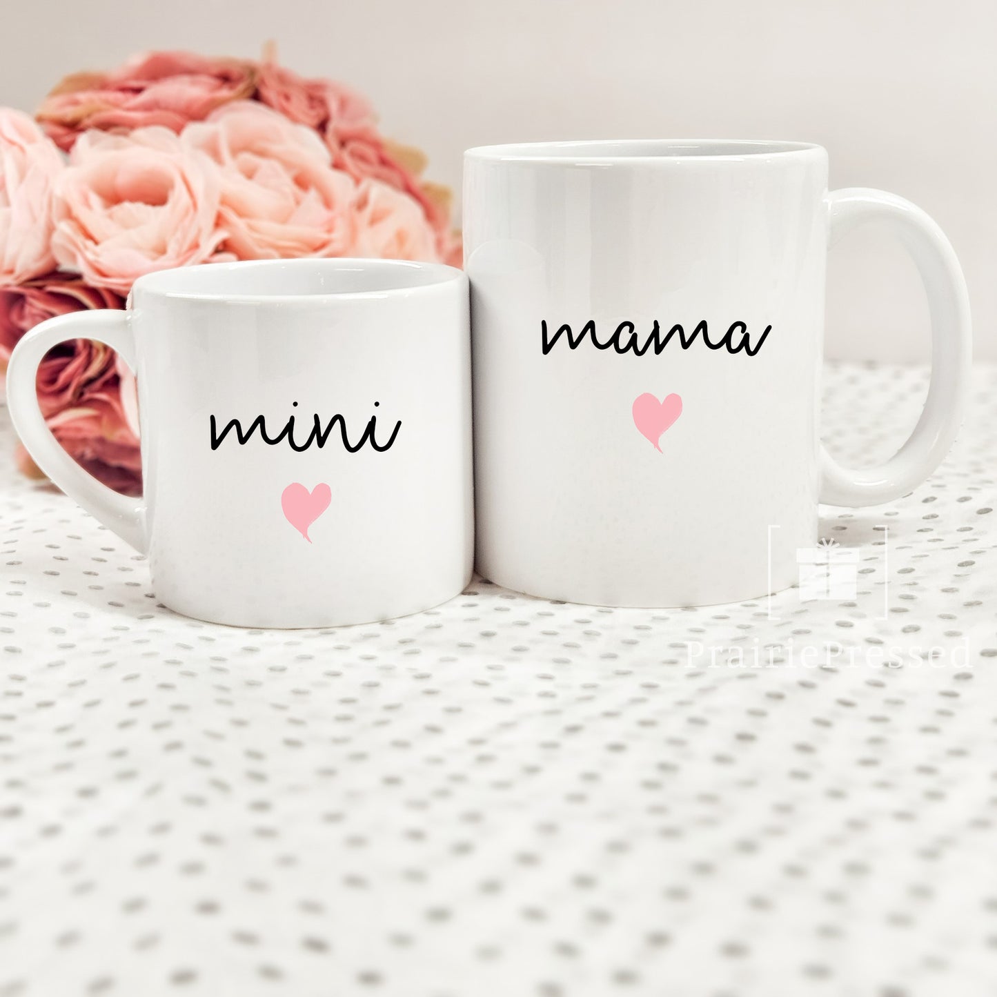 Adorable Mama Mini Ceramic Mother's Day Mug set with cute font and pink heart on each. Mug set includes one child size 5oz white mug and one 11oz white standard coffee mug