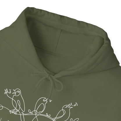 Close-up of a green hoodie with white bird design and text "I will Sing of the Goodness of God" on a white background