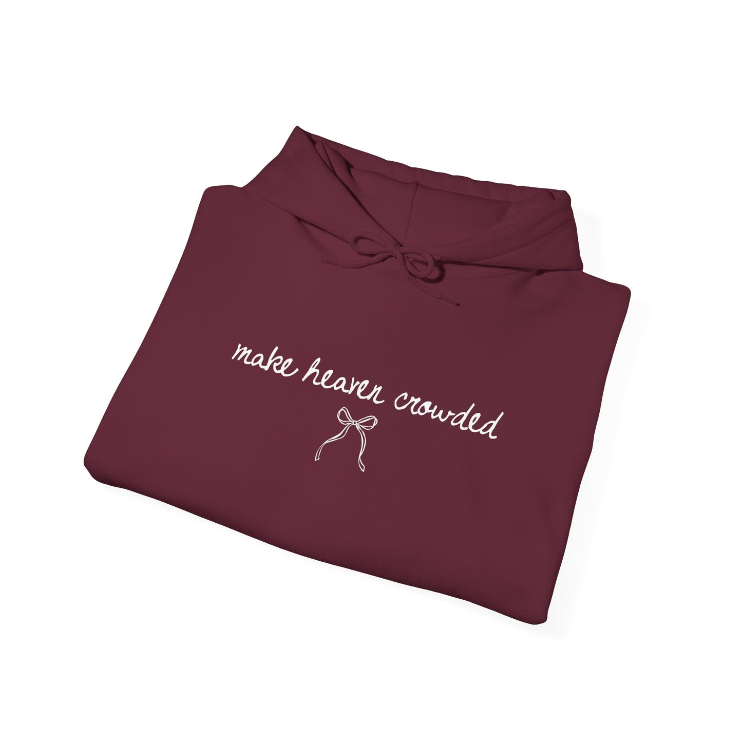 Folded maroon hoodie with 'make heaven crowded' text on a white background