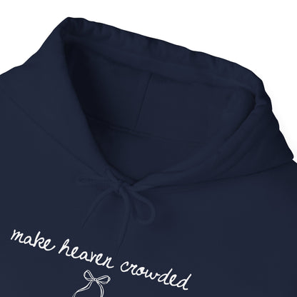 Navy blue hoodie with 'make heaven crowded' text and bow design on a white background