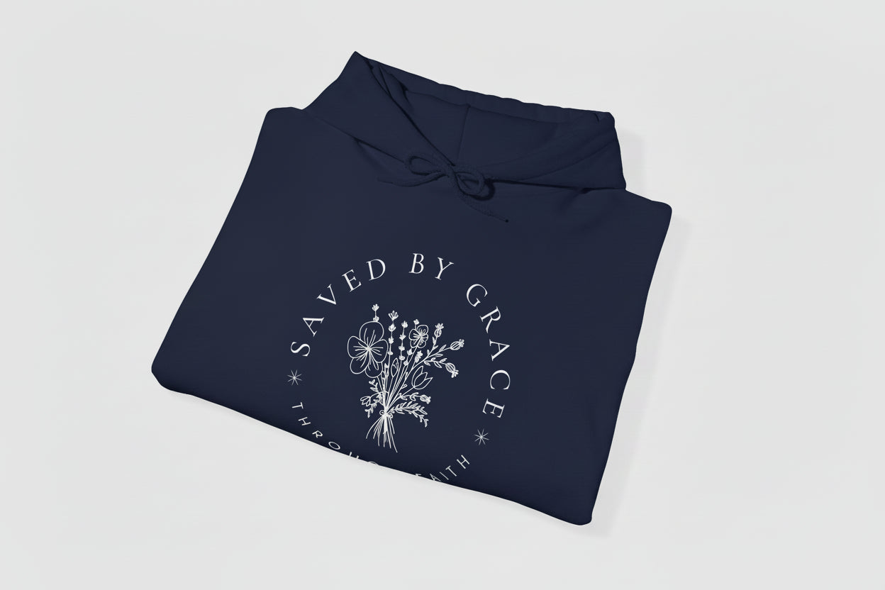 Folded navy blue hoodie with 'Saved by Grace' text and floral design on a white background