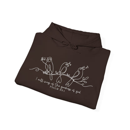 Folded brown hoodie with white bird design and text "I will Sing of the Goodness of God" on a white background