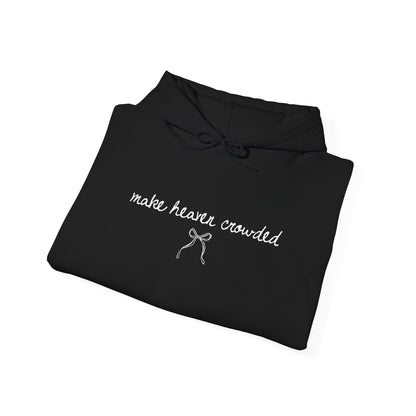 Folded black hoodie with white text and a bow graphic on a white background