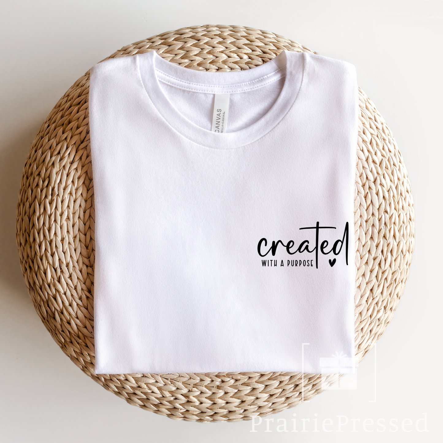 White Bella and Canvas Tshirt with cute modern font style Reading "Created with a Purpose" the T of the font is made to be a cross
