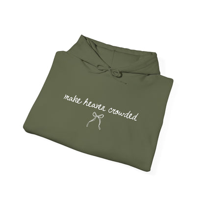 Folded olive green hoodie with text and a bow design on a white background