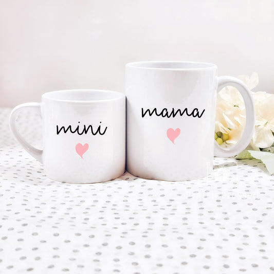 Adorable Mama Mini Ceramic Mother&#39;s Day Mug set with cute font and pink heart on each. Mug set includes one child size 5oz white mug and one 11oz white standard coffee mug