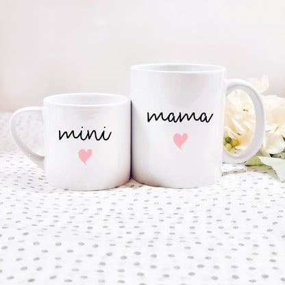 Adorable Mama Mini Ceramic Mother&#39;s Day Mug set with cute font and pink heart on each. Mug set includes one child size 5oz white mug and one 11oz white standard coffee mug