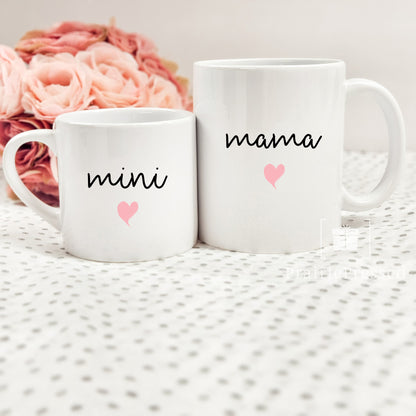 Adorable Mama Mini Ceramic Mother&#39;s Day Mug set with cute font and pink heart on each. Mug set includes one child size 5oz white mug and one 11oz white standard coffee mug