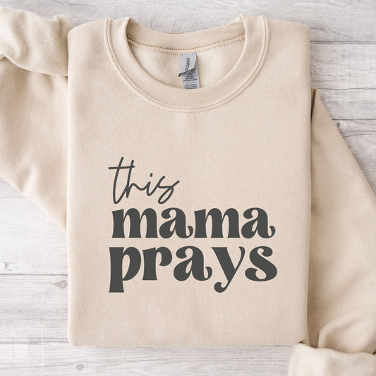 This Mama Prays Gildan Crewneck Cozy Sweatshirt in Sand Color.