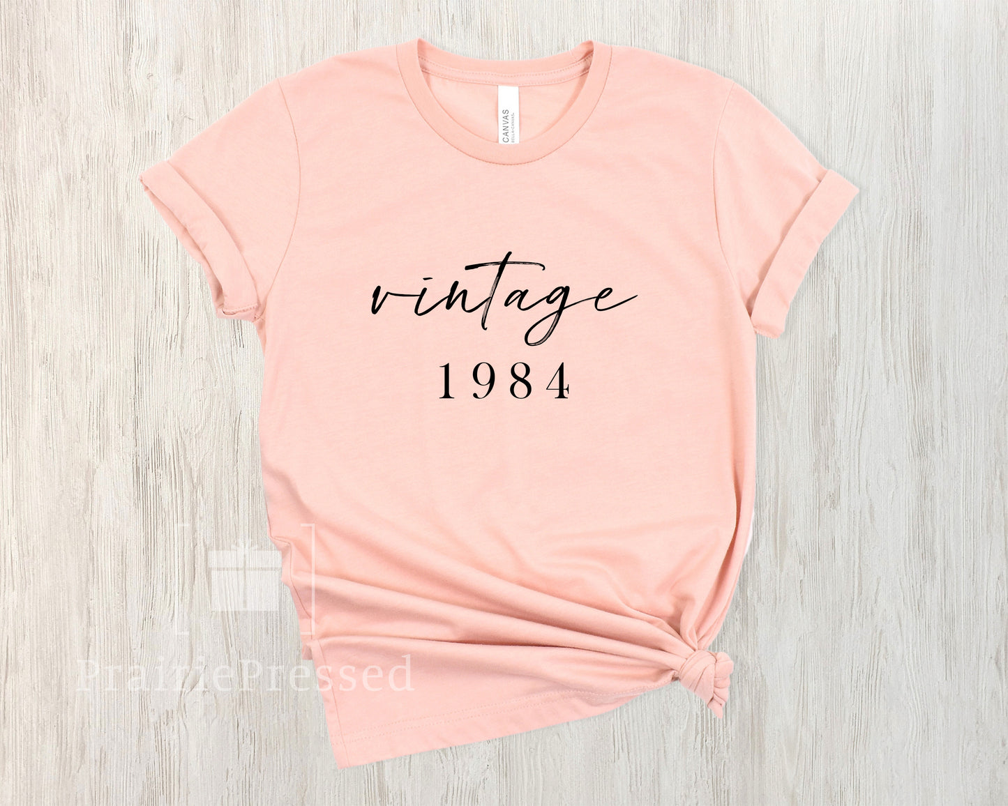 Peach Color Soft Tshirt with the Phrase Vintage 1974 in beautiful font. The Date can be customized for birthday 